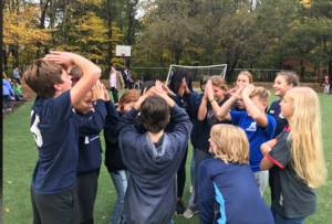 students huddle in soccer match